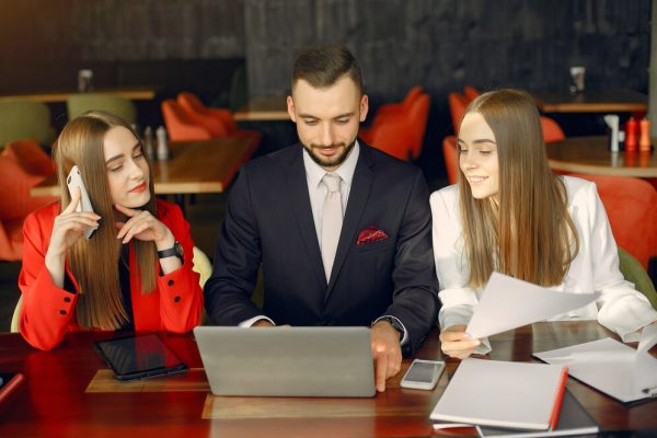 partners-sitting-table-working-cafe_1157-28449